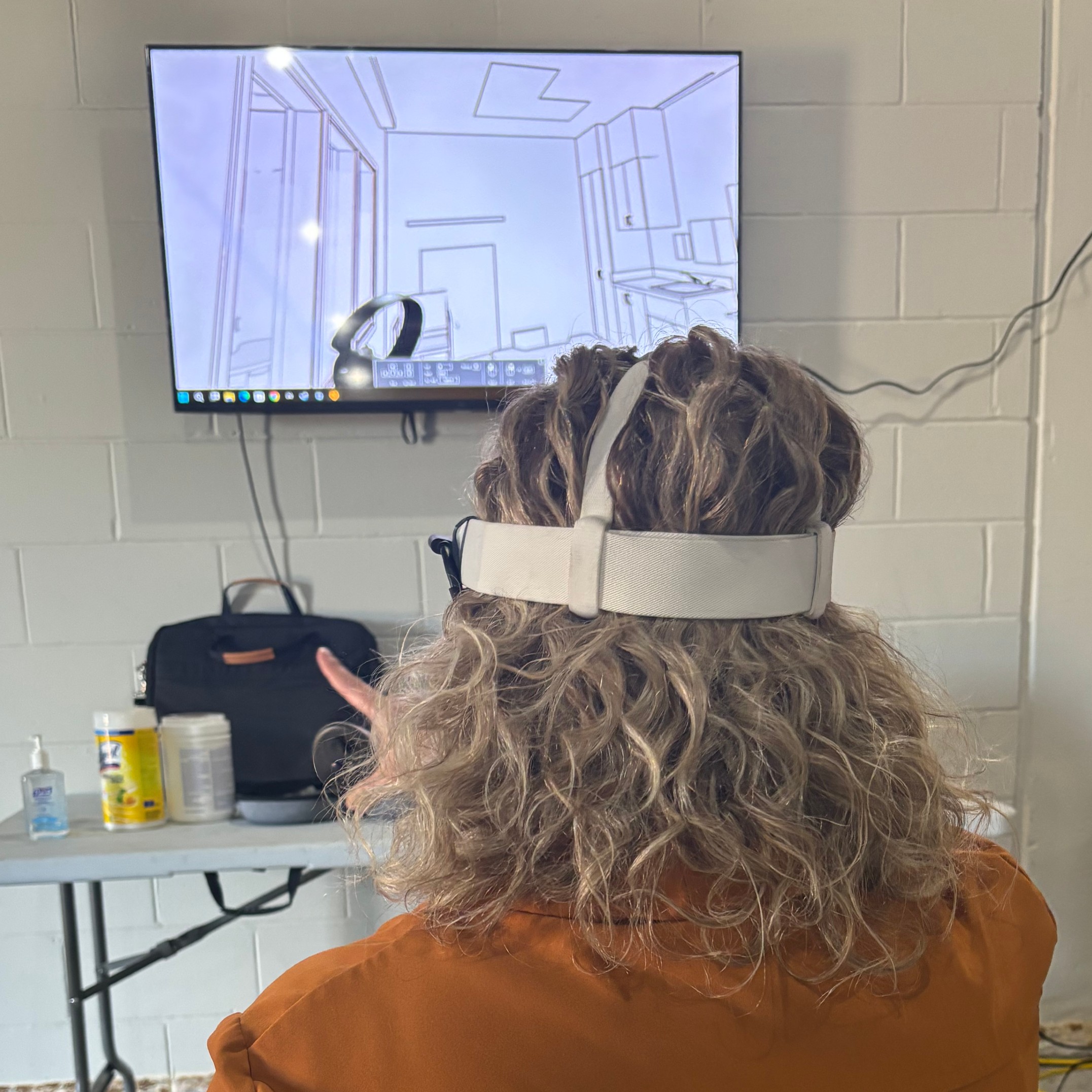 woman uses virtual reality headset and looks at layout of new building