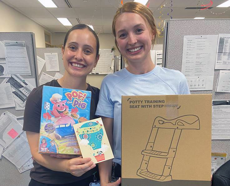 cheo staff members hold items gifted to them by family of child they treated