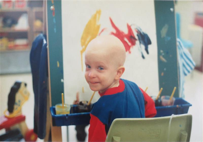 A boy with no hair painting