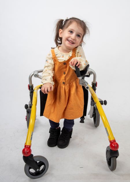 girl smiles while using Trexo robotic walker