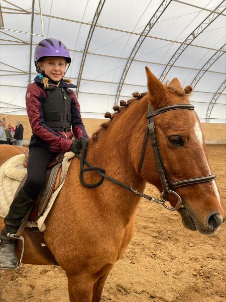 girl sits on horse