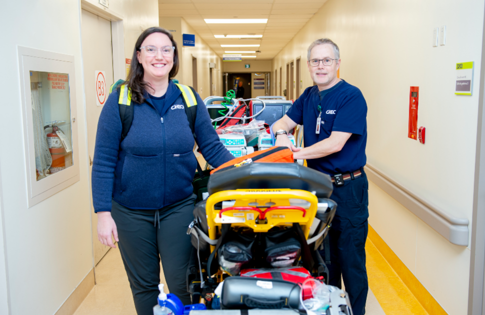 transport team members stand with transport stretcher in cheo hallway